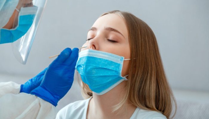 doctor-taking-nasopharyngeal-culture-pcr-test-to-woman-patient-nurse-take-saliva-sample-through-nose-with-cotton-swab-to-check-coronavirus-covid-19-long-web-banner-scaled-1-1280x720-1.jpg
